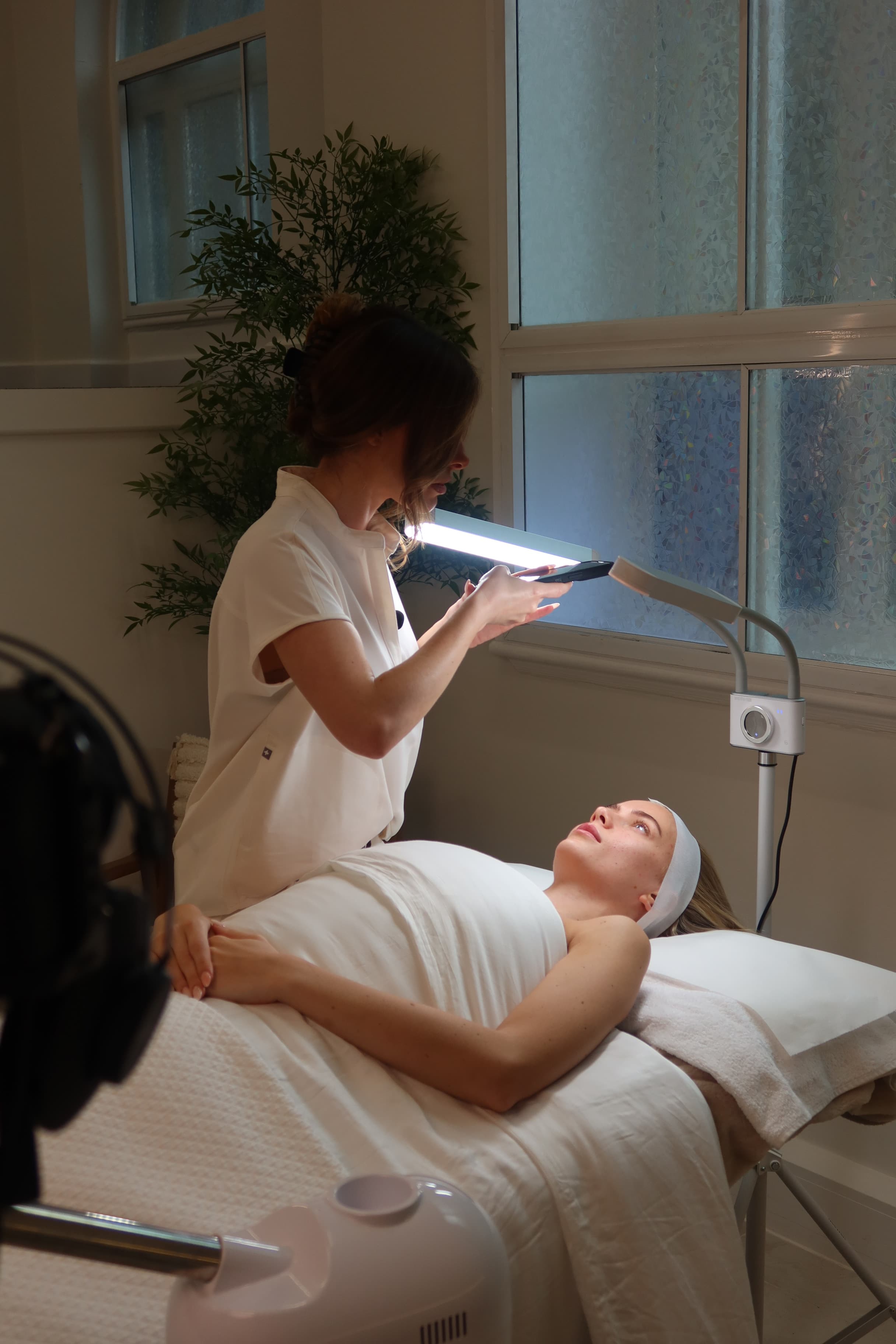 A skincare professional treating a client alone in a quiet clinic